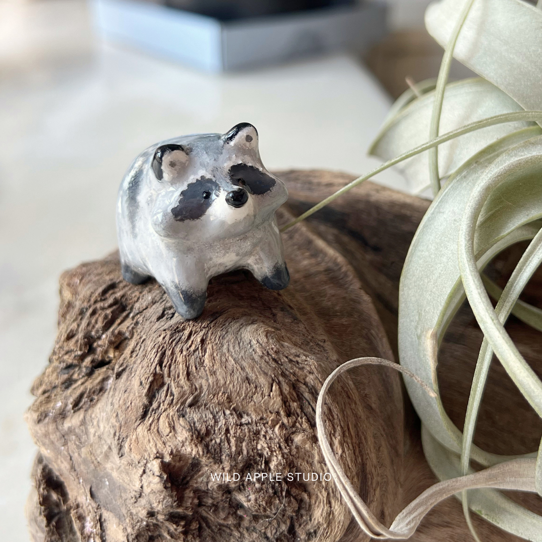 A handcrafted jimothy raccoon figurine